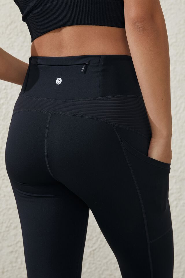 Lululemon 7/8 length black leggings with mesh at calf and zipper pockets  size 8