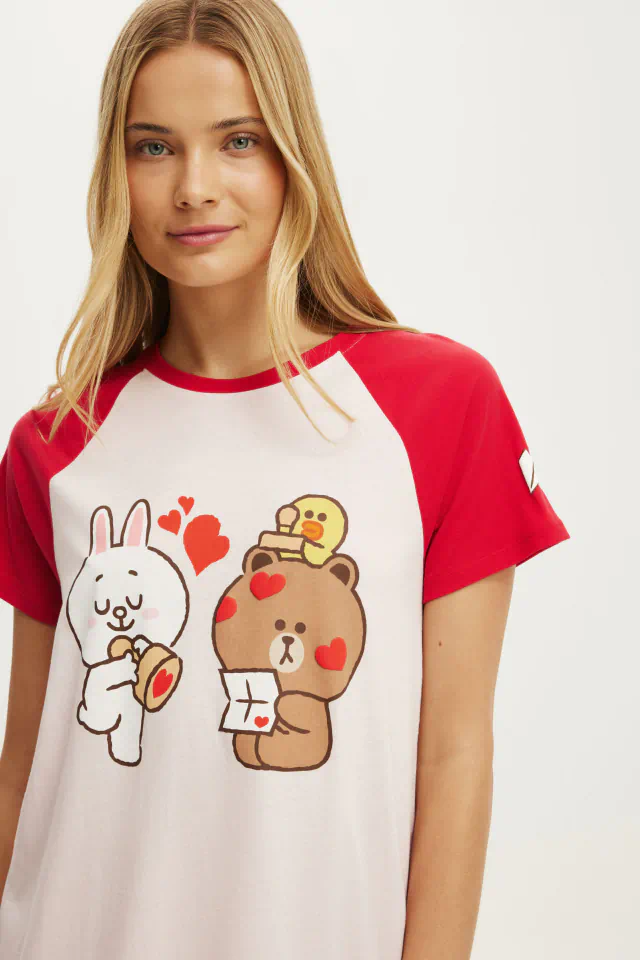 Woman wearing red and white raglan t-shirt with cute cartoon characters and hearts graphic design