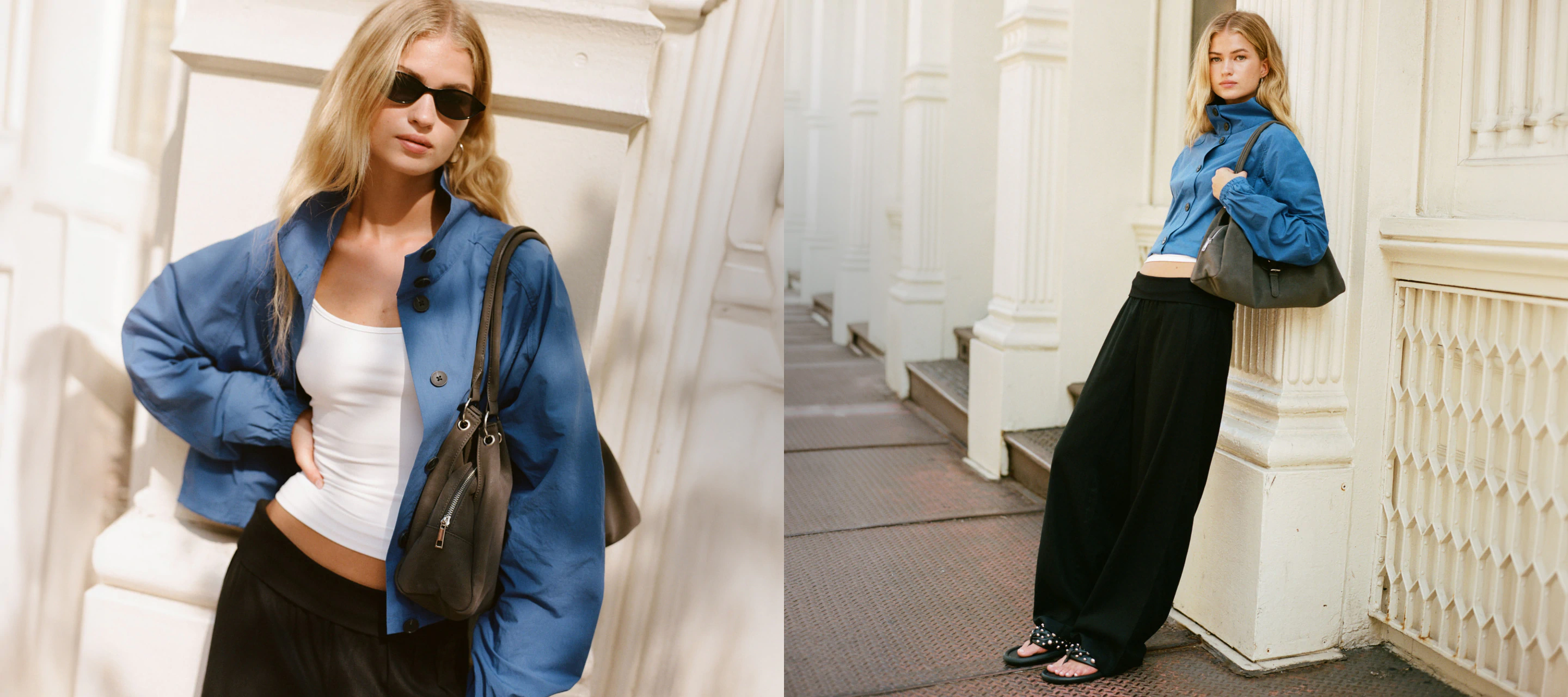 Woman wearing blue jacket, white crop top, and black pants with brown shoulder bag, standing in stairwell
