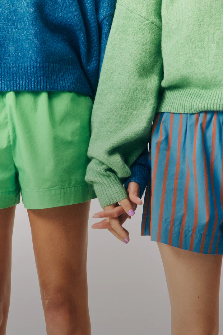 Two young people holding hands.