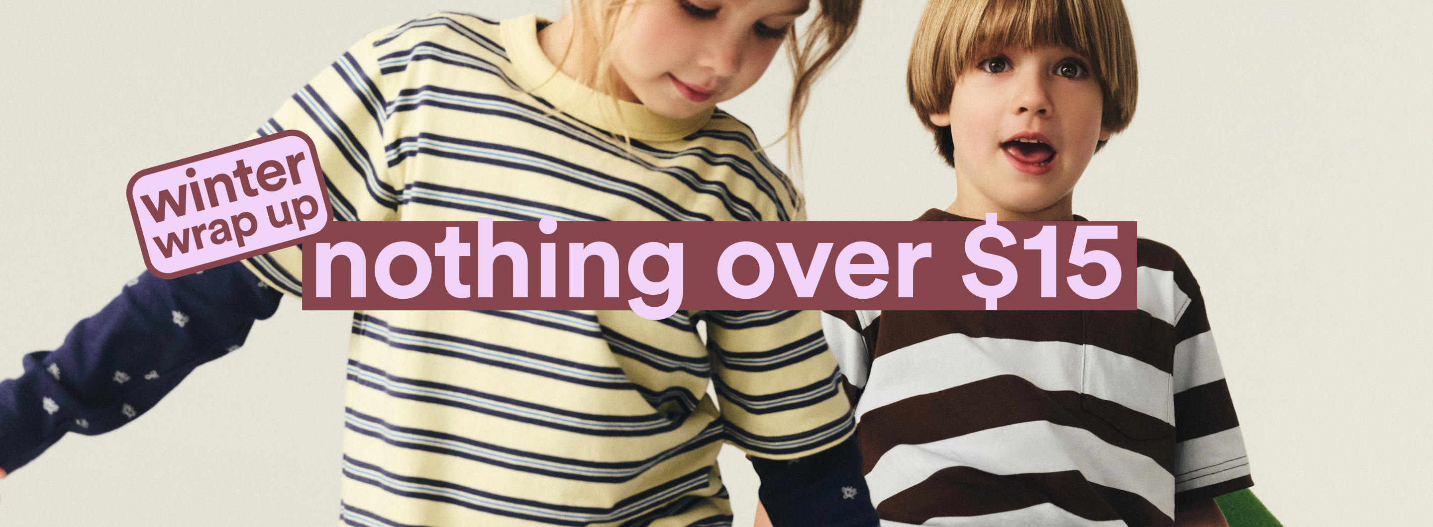 Two children wearing striped long-sleeve shirts. Text overlay reads "winter wrap up nothing over $15