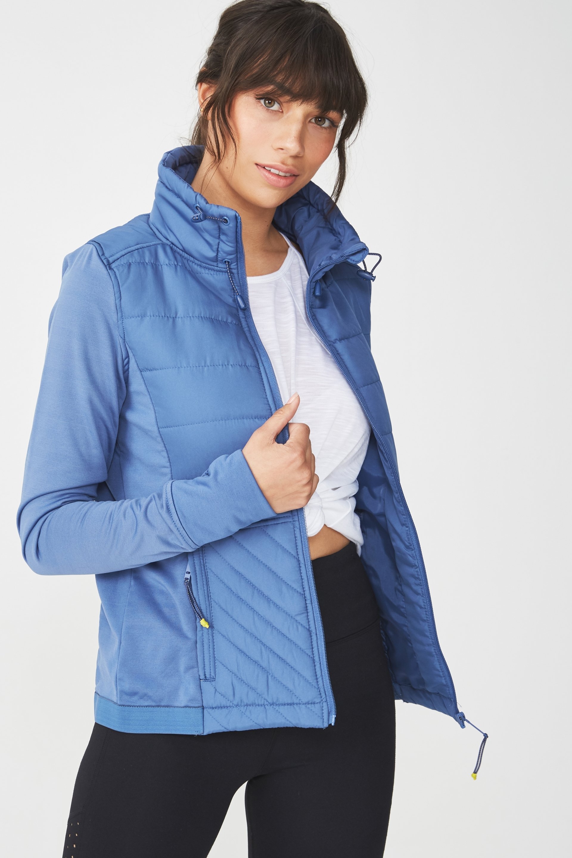 The Active Slimline Puffer Jacket is fitted with jersey side panels and sleeves that create a flattering shape. This winter puffer jacket is a workout wardrobe must-have with thumbholes in the cuffs keep your hands warm on cooler mornings. - Extra length at the back for more coverage - Comfortable relaxed fit - Zipper front - Tunnel shaped neckline - Drawcord with adjustable toggles - Elasticated waistband - Zip pockets - Soft fabric lining MODEL WEARS SIZE: SMALL - AU 10 US 6 EUR 38 BODY: 100% POLYESTER CONTRAST PANEL: 97% POLYESTER 3% ELASTANE LINING: 100% POLYESTER FILLING: 100% POLYESTER